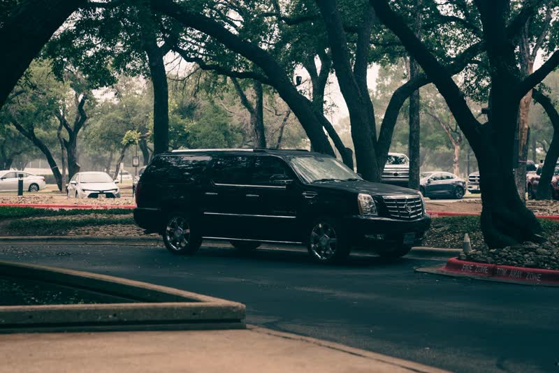 Suburban SUV — black chauffeured vehicle